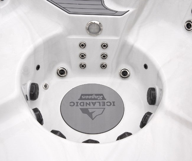 Center footwell of the Icelandic Cyclone 3 spa featuring multiple lower-body jets and branded floor plate.