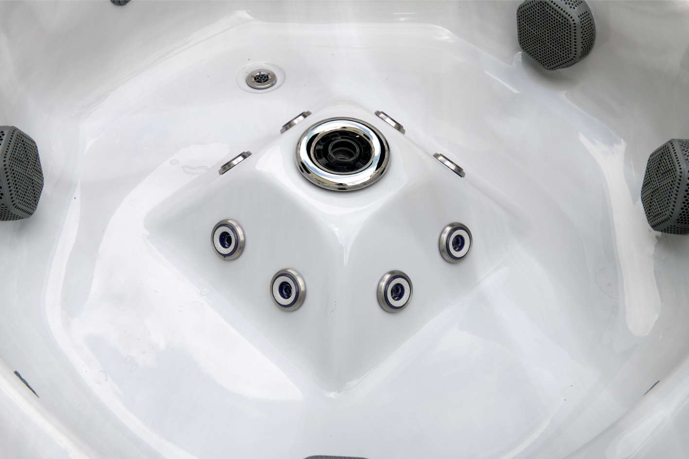 Close-up of the Oasis hot tub center foot dome with massaging foot jets and central intake.