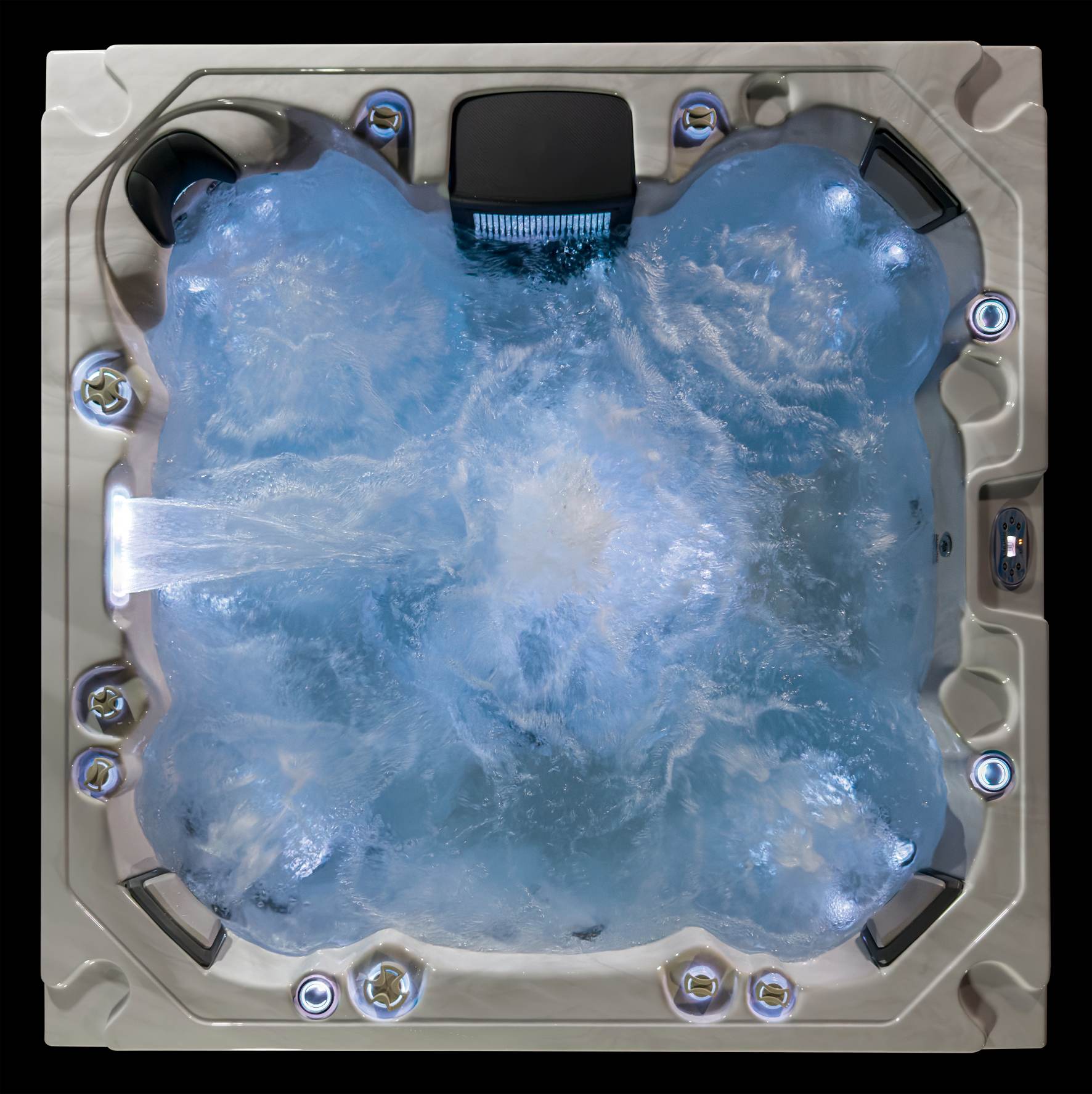 Top-down view of the Oasis hot tub with jets running and soft blue LED illumination.