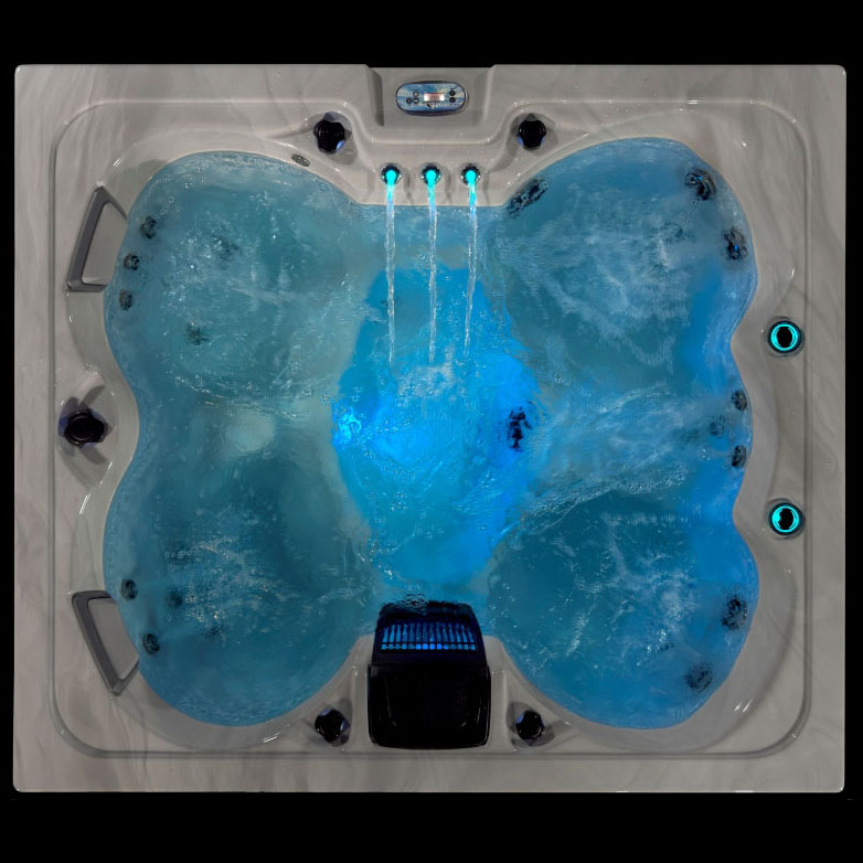 Top-down view of the Aurora hot tub with glowing blue interior lighting and active water jets.
