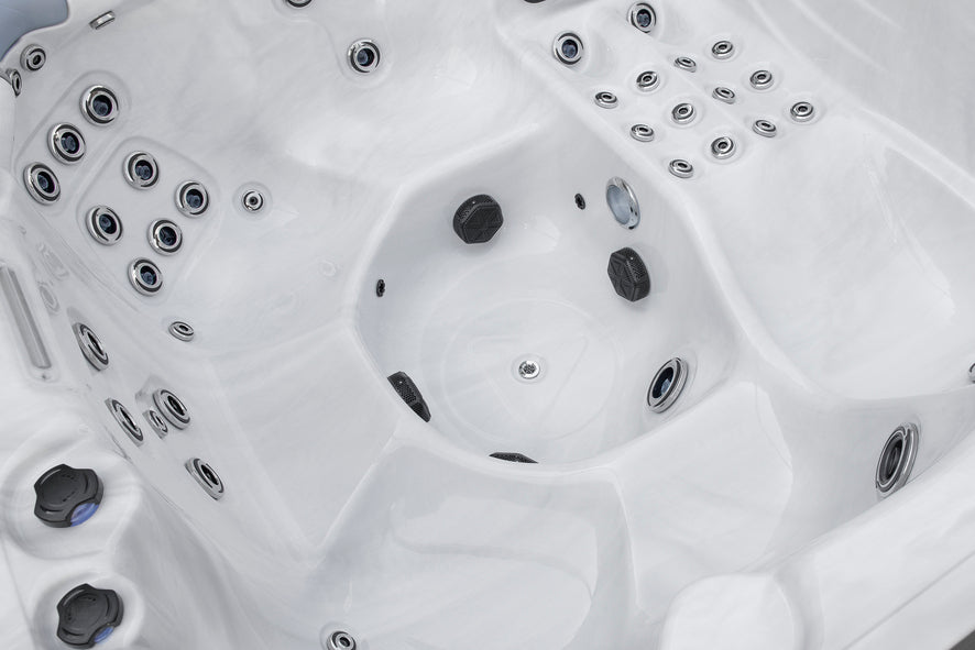 Deep footwell area of a Fjord hot tub featuring massage jets and ergonomic seating.