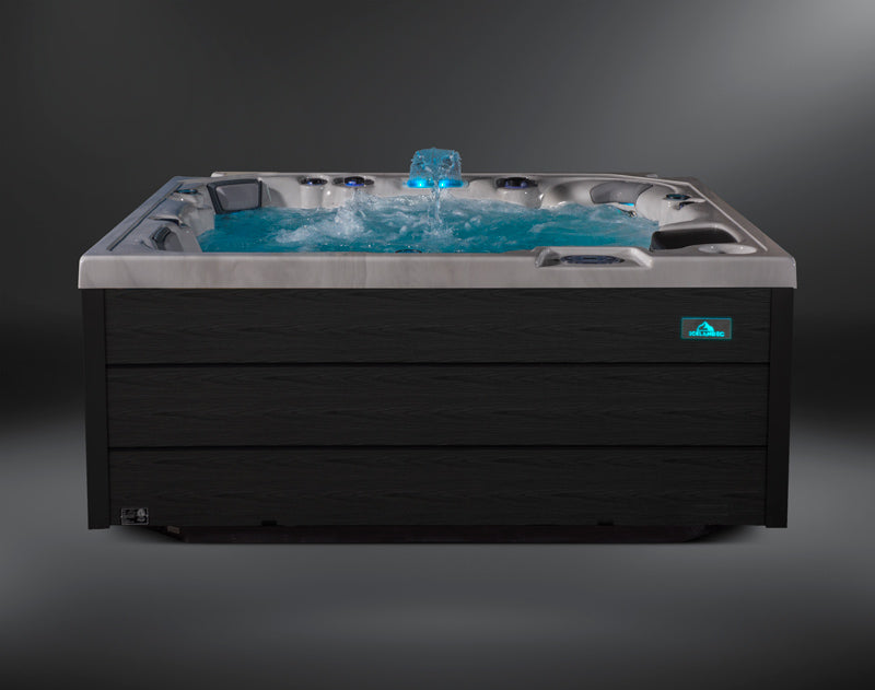 Front view of the Fjord hot tub featuring cascading waterfall and glowing LED accents.