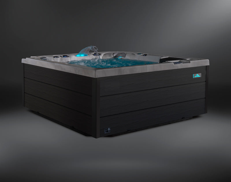 Fjord hot tub side-angle view with blue LED waterfall and bubbling water.
