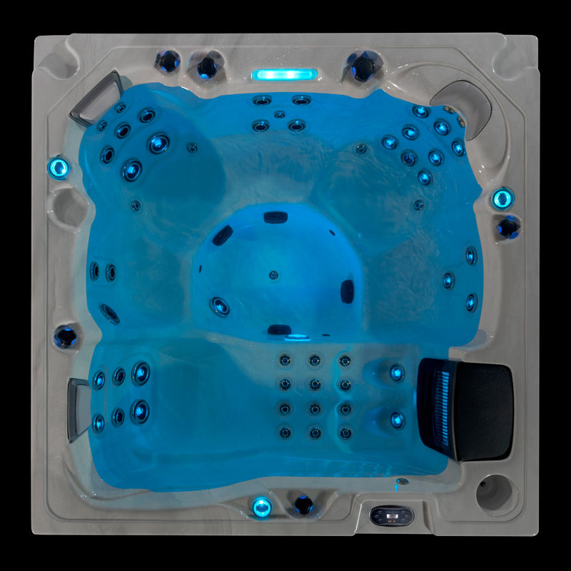 Top-down view of the Fjord hot tub illuminated with blue LED lighting and multiple jet seats.