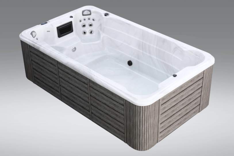 Angled view of empty Fossa pp spa with white interior and gray exterior panels.