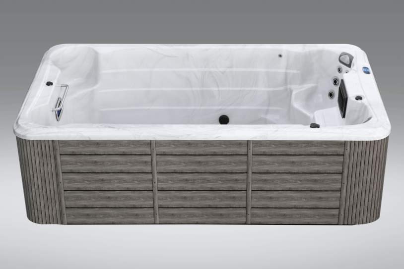 Fossa PP front-facing view of empty Icelandic swim spa showing white interior design and jet layout.