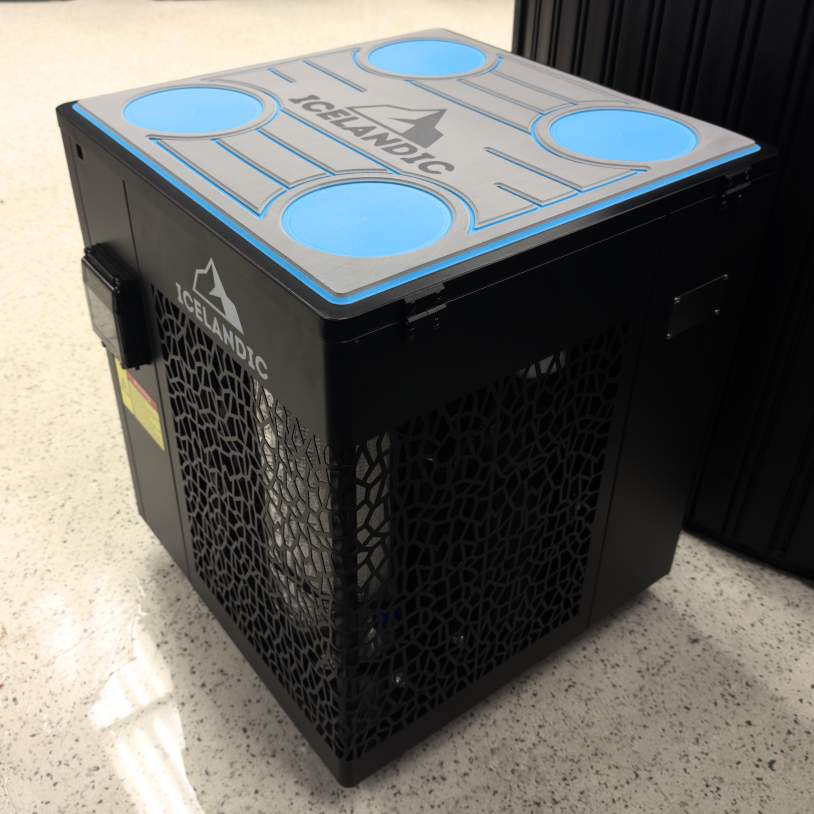 Side-angle image of the Icelandic chiller next to a cold-plunge tub, showing the vented side panel design.