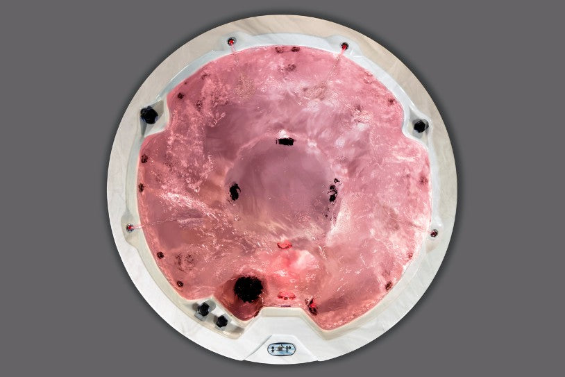 Red LED lighting inside the Icelandic Cyclone 1 hot tub, seen from a top-down view with water motion.
