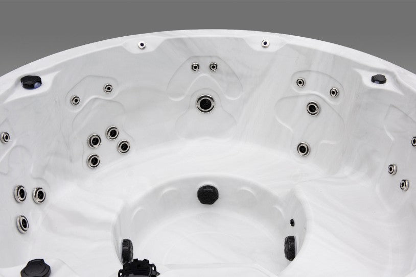 Close-up of the Cyclone 1 hot tub's hydrotherapy jet clusters along the inner seating walls.