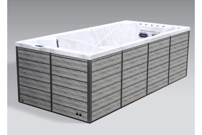 Side angled view of the Icelandic swim spa showcasing exterior siding and spa structure.