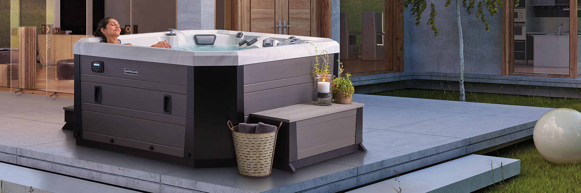 Outdoor lifestyle photo of a woman relaxing in a Vector21 Series V77L hot tub on a modern patio.