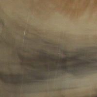 Tuscan Sun hot tub shell sample with warm brown, amber, and cream marbling.