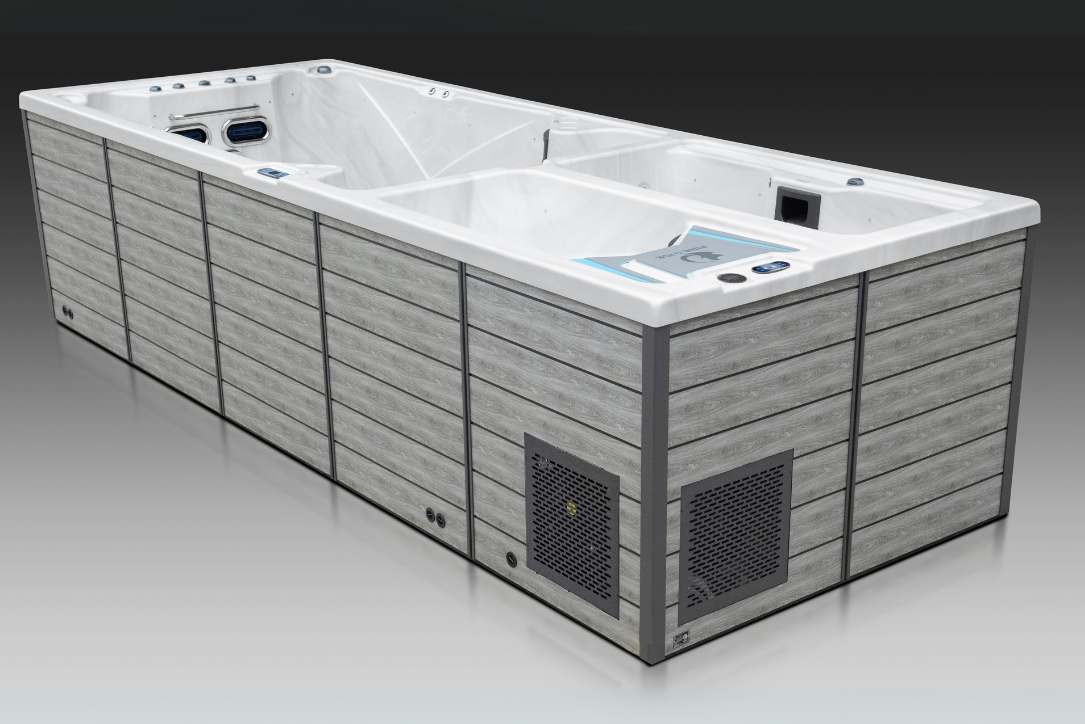 Side view of the Triathlon 3-in-1 swim spa featuring gray exterior panels and compartment layout.
