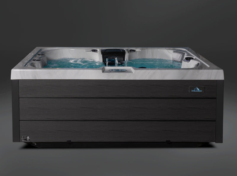Front view of the Aurora hot tub displaying the water features, LED accents, and sleek modern cabinet.