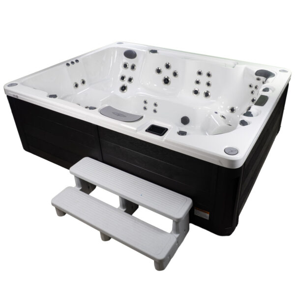 Side view of the H2810L hot tub with white interior, black exterior panels, and included spa steps.
