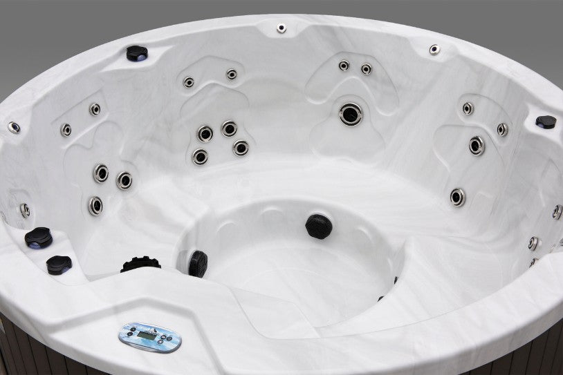 Side interior view of the Icelandic Wellness Cyclone 1 hot tub showing multiple hydrotherapy jets and contoured seating.