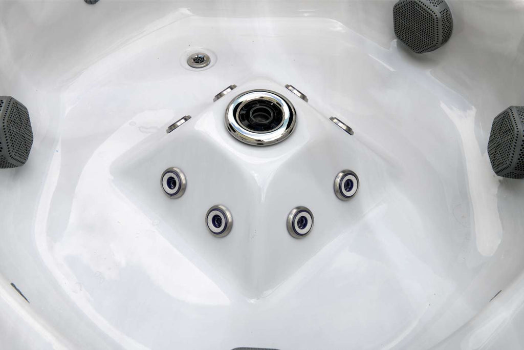 Close-up of the Oasis hot tub center foot dome with massaging foot jets and central intake.