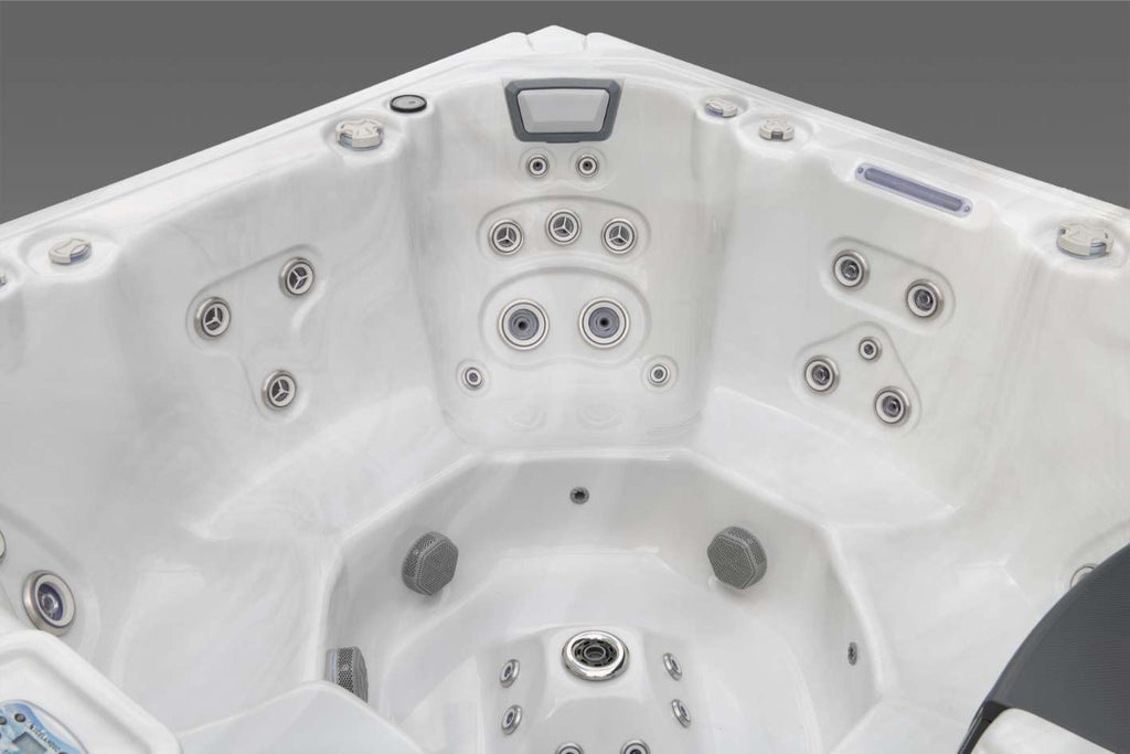 Corner therapy seat in the Oasis hot tub with a multi-level hydrotherapy jet configuration and contoured seating design.