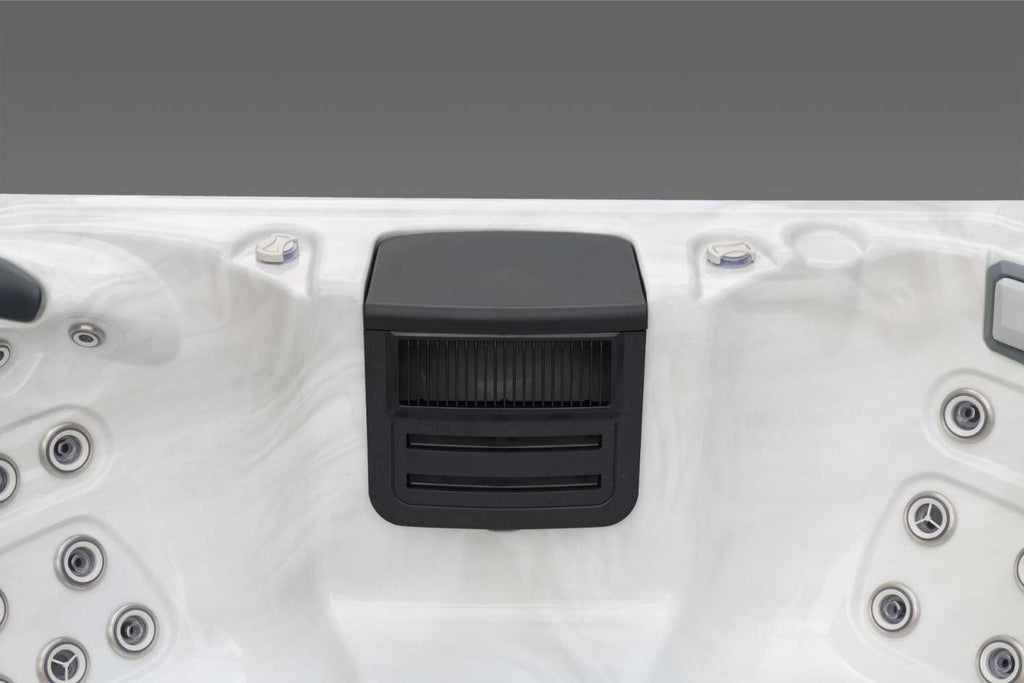 Oasis hot tub filter housing centered between jet groups on the upper shell.