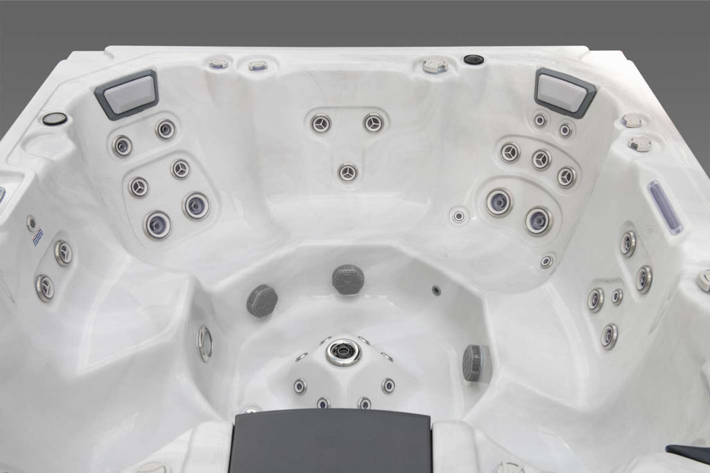 Wide interior view of the Oasis hot tub showcasing the full seating layout, hydrotherapy jets, foot dome, and headrests.