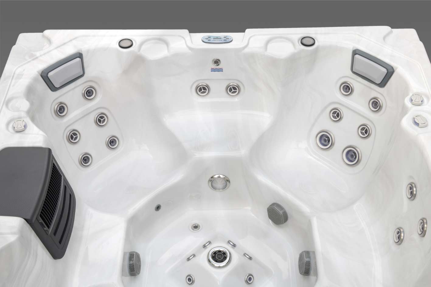 Oasis hot tub interior showing dual therapy seats, stainless steel jets, footwell dome jets, and integrated speakers.