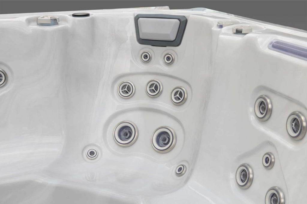 Oasis hot tub multi-level therapy seat with pillow headrest and multiple targeted jets.