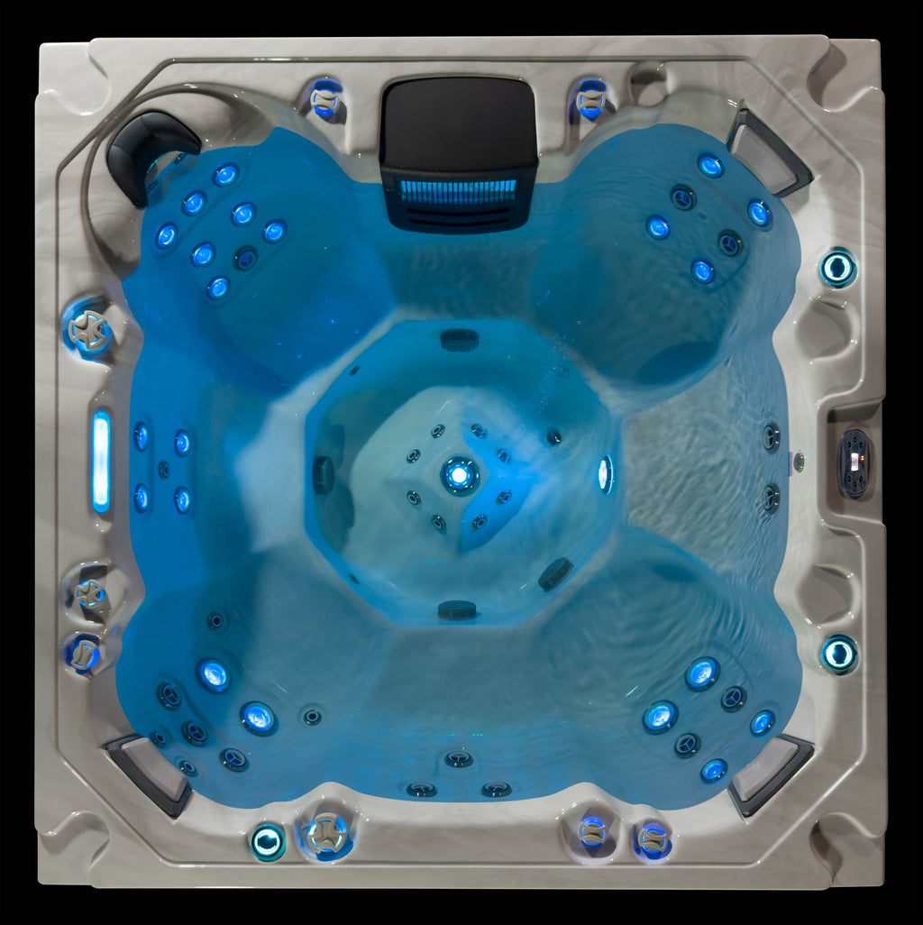 Top-down view of the Oasis hot tub with calm water, LED lighting, and full seating layout.