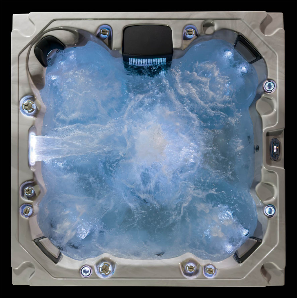 Top-down view of the Oasis hot tub with jets running and soft blue LED illumination.