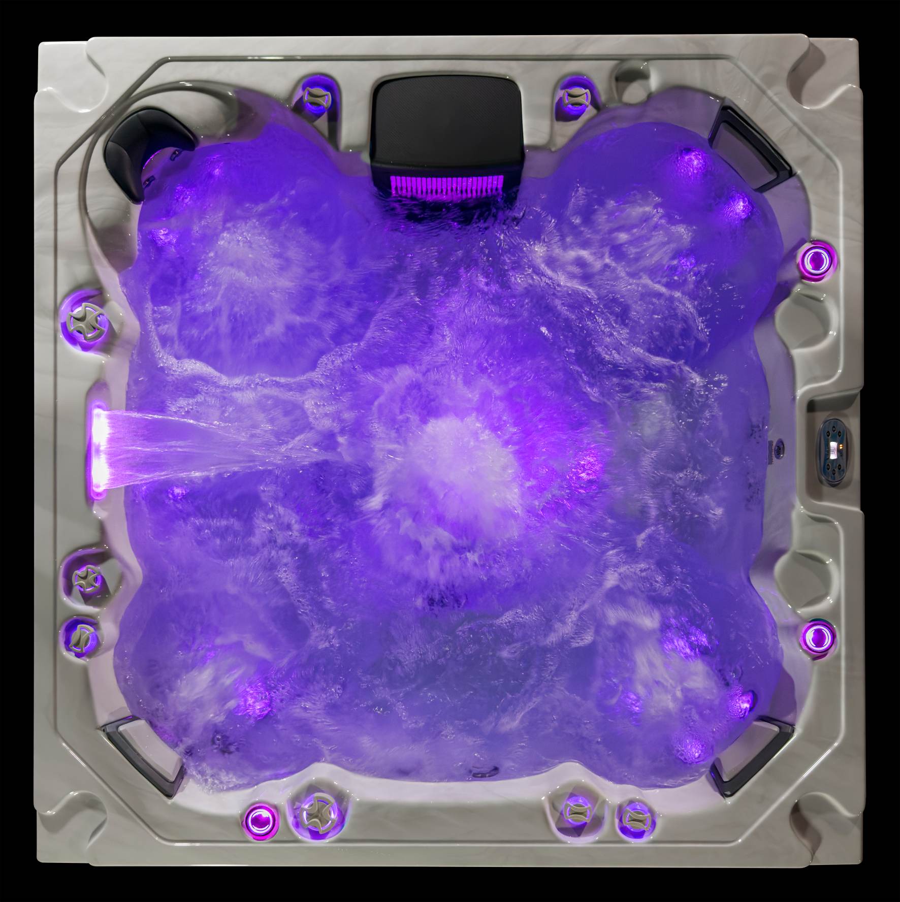 Top-down view of the Oasis hot tub illuminated with purple LED lighting and active jets.