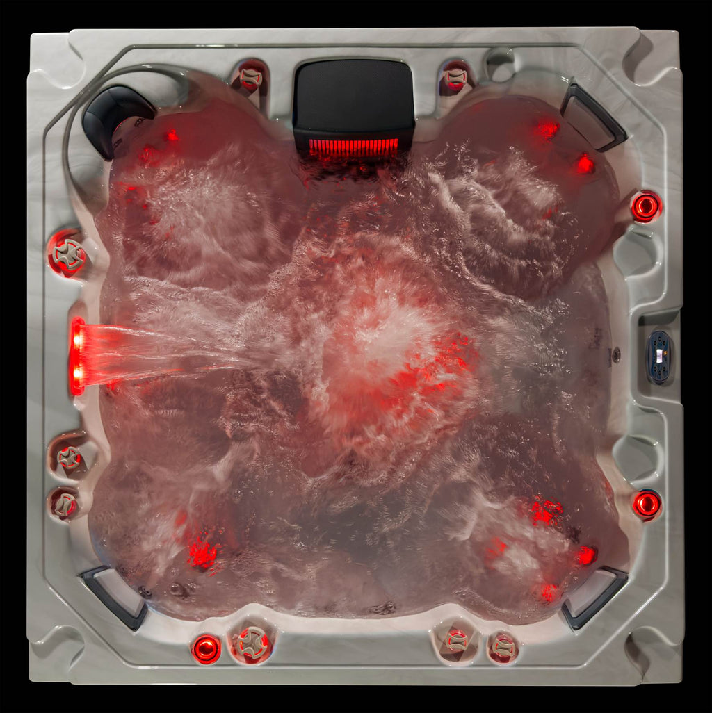 Top-down view of the Oasis hot tub illuminated with red LED lighting and jets running.