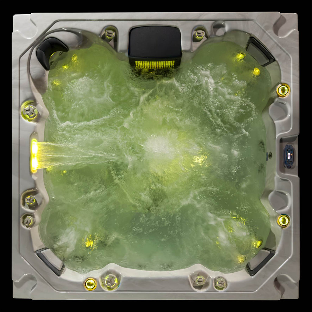Oasis hot tub top view with warm yellow LED lighting and active hydrotherapy jets.