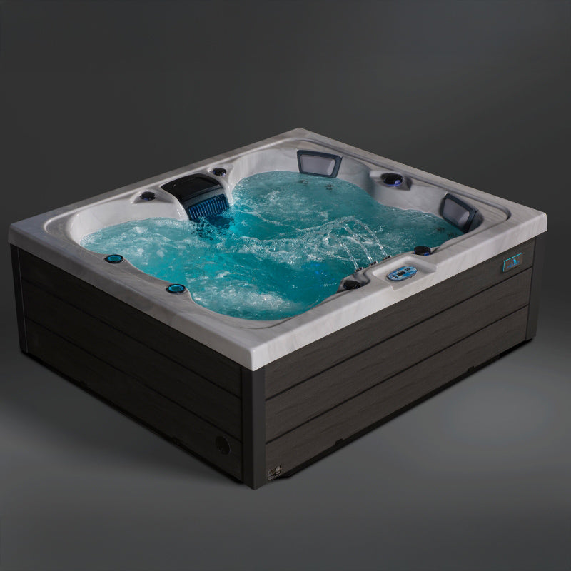 Corner angle photo of the Aurora hot tub with bubbling water and ergonomic seating.