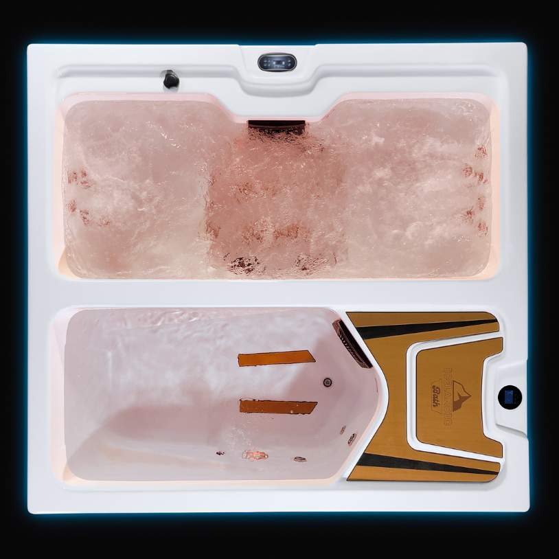 Fire & Ice dual-zone tub illuminated in amber lighting with bubbling hydrotherapy section.