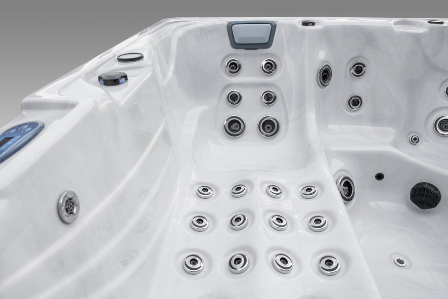 Interior view of a Fjord luxury hot tub showing massage jets, lounger, and control panel.