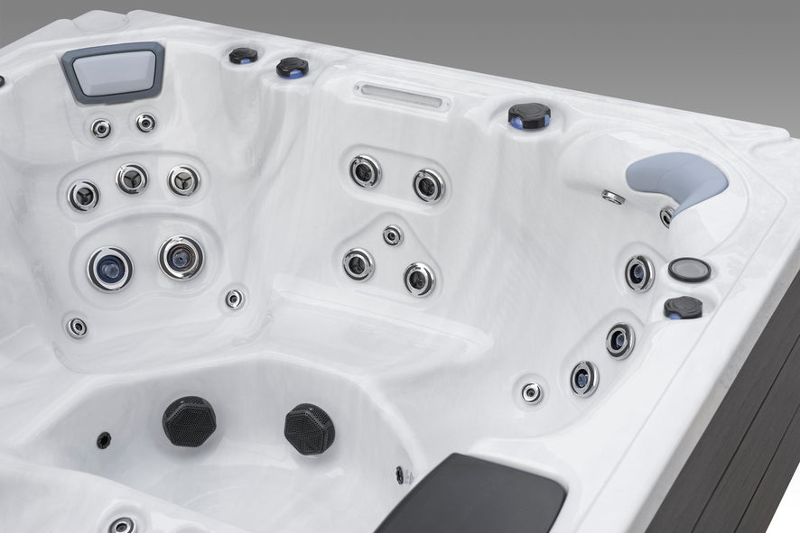 Fjord corner hot tub seat equipped with premium hydrotherapy jets and cushioned headrest.