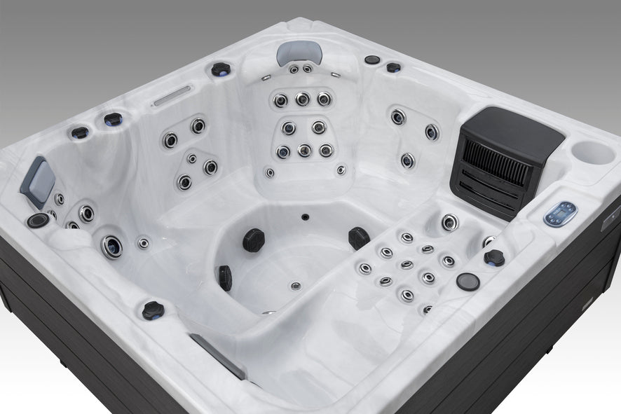 Overhead angle of a multi-seat Fjord spa with a lounger and full hydrotherapy jet layout.