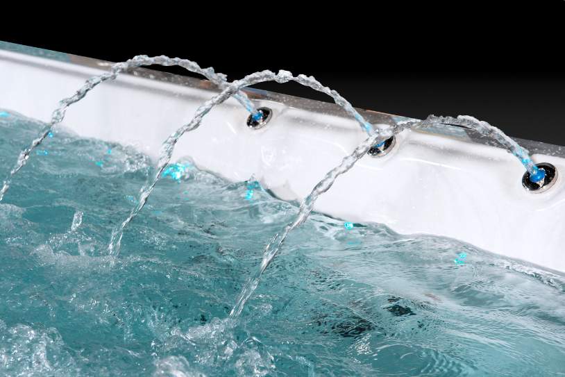Arc-style water features on the Fossa-3B swim spa creating decorative cascading streams.