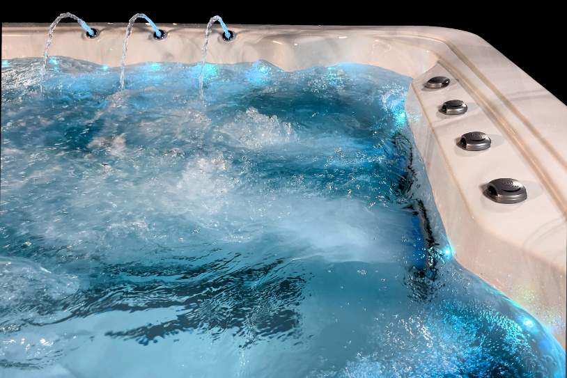 Close-up of active water jets and illuminated water surface inside the Fossa 3B spa.