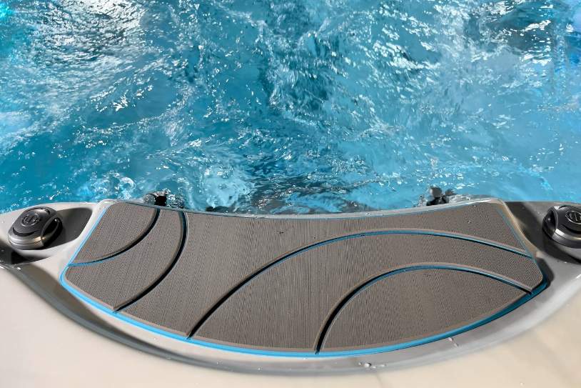 Non-slip entry step of the Fossa-3B swim spa with textured grip surface near the waterline.