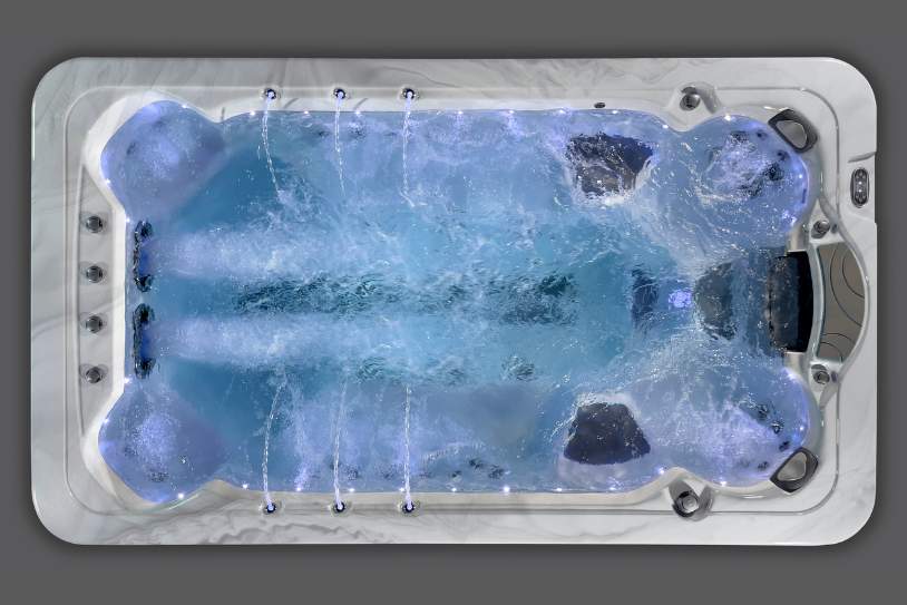 Overhead shot of the Fossa-3B swim spa lit with cool white LEDs and active water movement.