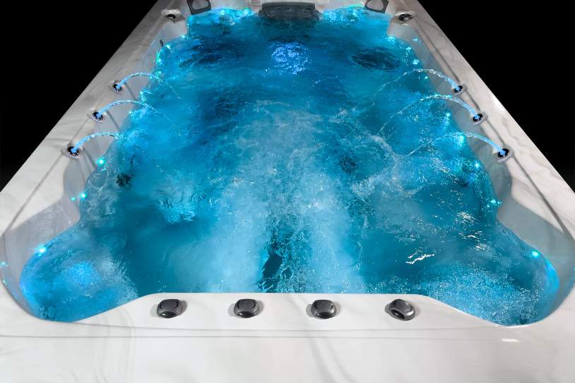 Fossa 3B spa with illuminated water features and powerful jets during operation.