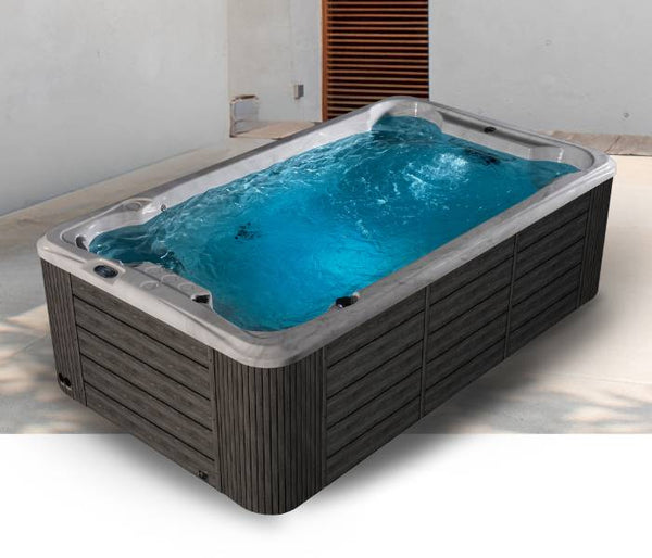 Fossa PP outdoor swim spa with dark wood-style panels and clear blue water in a modern patio setting.