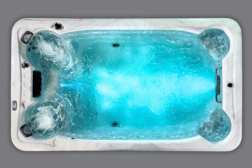 Fossa PP top view of the Icelandic Swim Spa filled with blue glowing water and active hydrotherapy jets.