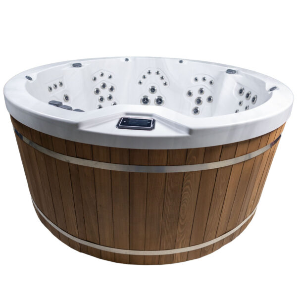 Round Harmonic hot tub with natural wood barrel-style exterior and multiple interior jets.