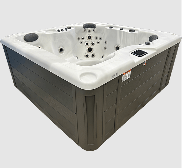 Side view of the Harmonic H277L hot tub featuring a white acrylic shell and gray exterior cabinet panels.