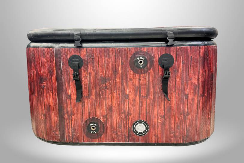 Back view of the Icelandic Air inflatable tub with wood-grain exterior and water inlet and outlet ports.