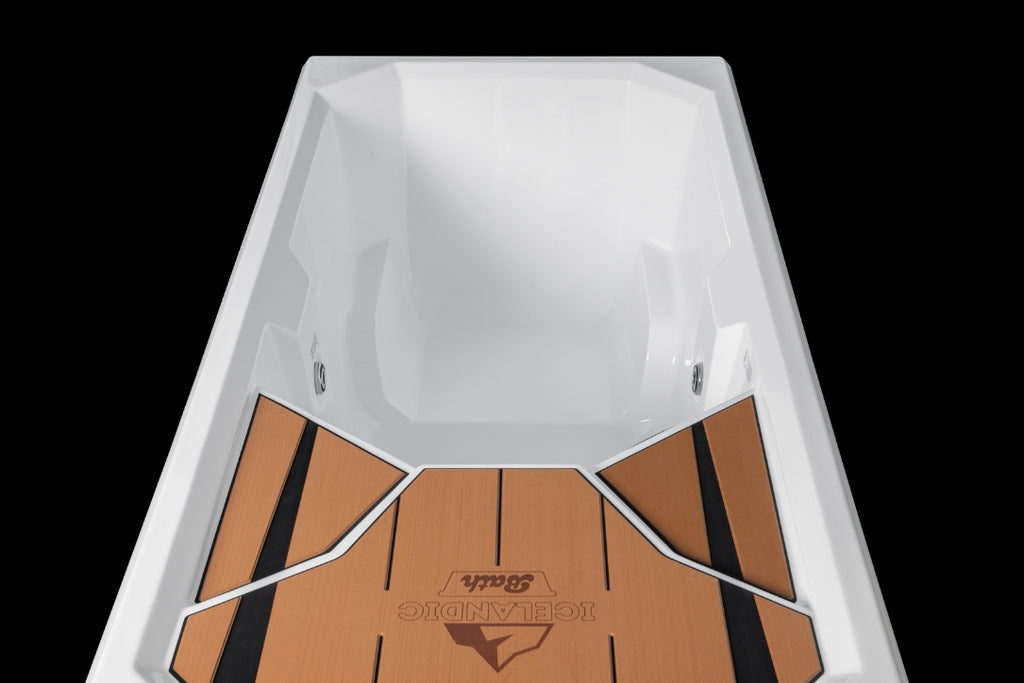 Interior view of the Icelandic Bath with the teak-style deck and step areas visible at the base of the tub.