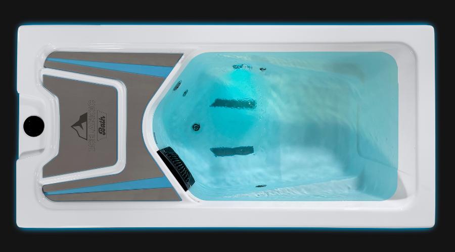 Overhead view of the Icelandic Bath cold plunge with bright aqua-blue illumination.