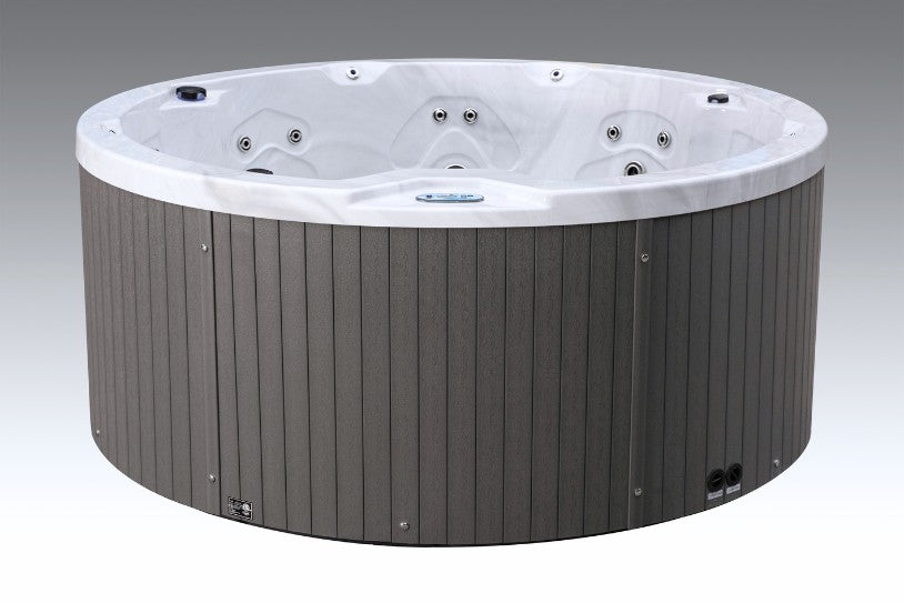 Round Cyclone 1 outdoor hot tub with gray exterior panels and white interior, shown empty from a front-angle view.