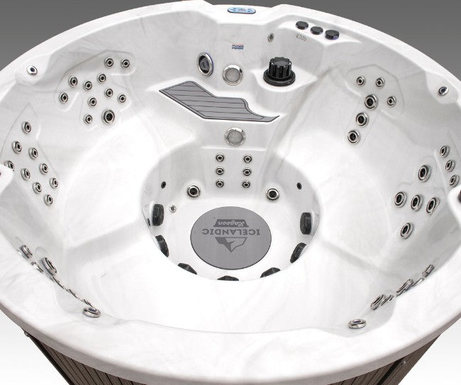 Interior view of the Icelandic Wellness Cyclone 3 hot tub showing multiple hydrotherapy jets, contoured seating, and a white marble-style shell.